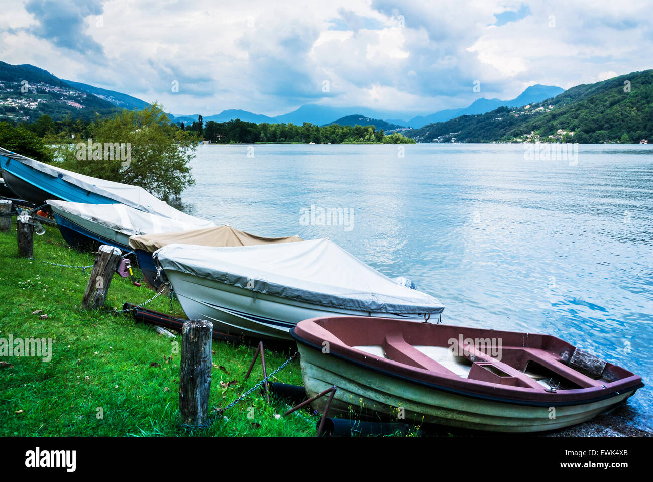 Lugano Lake, boats at rest on the grass in summer season, Switzerland Stock Photo