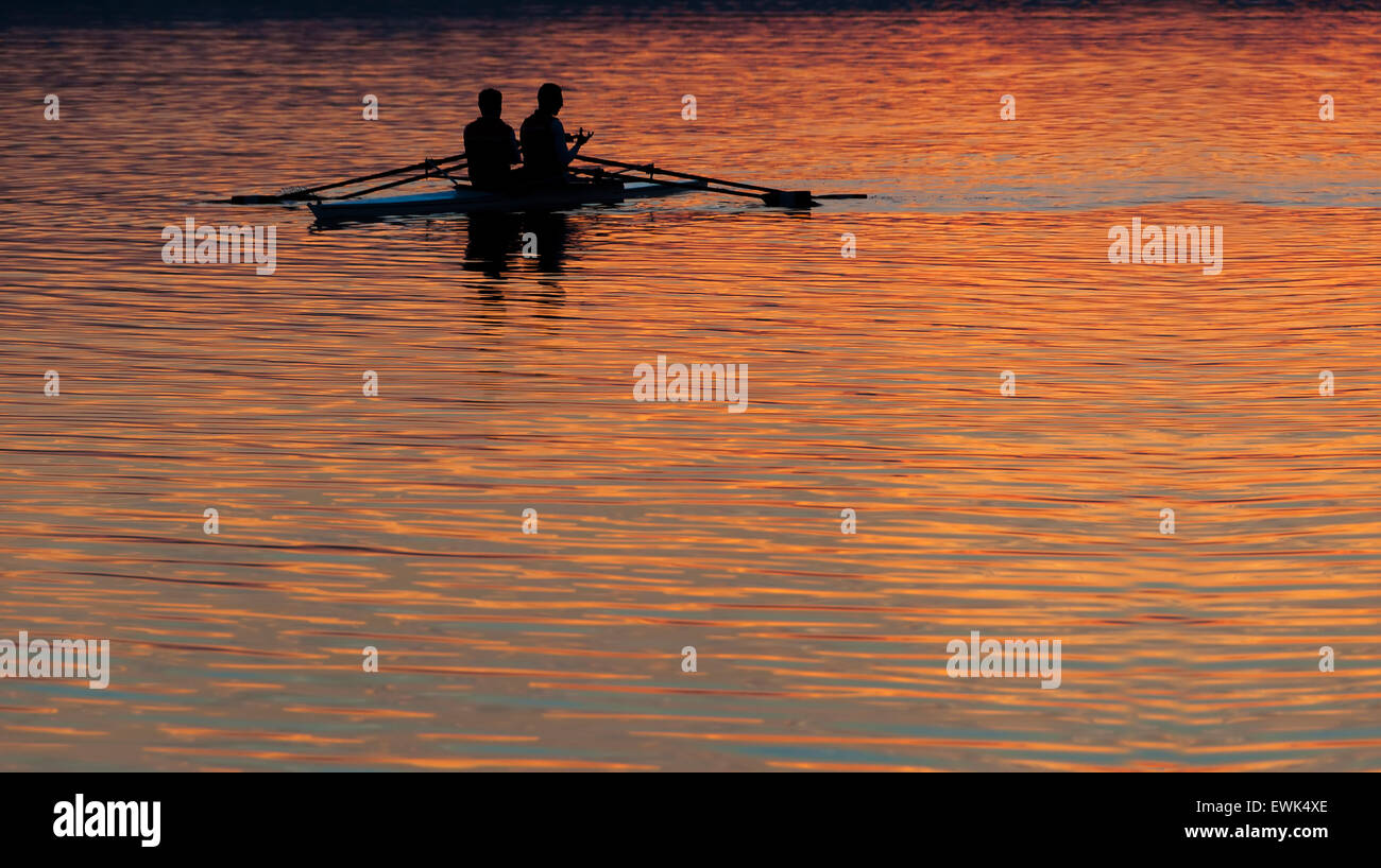 rowers on the river at the sunset Stock Photo