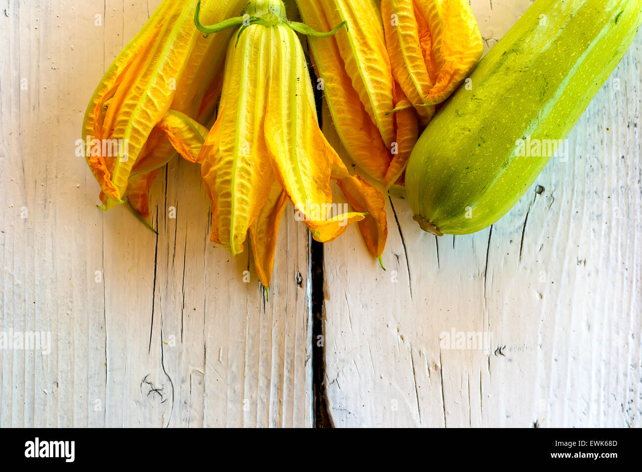 Edible flowers of courgettes and courgettes on a white table Stock