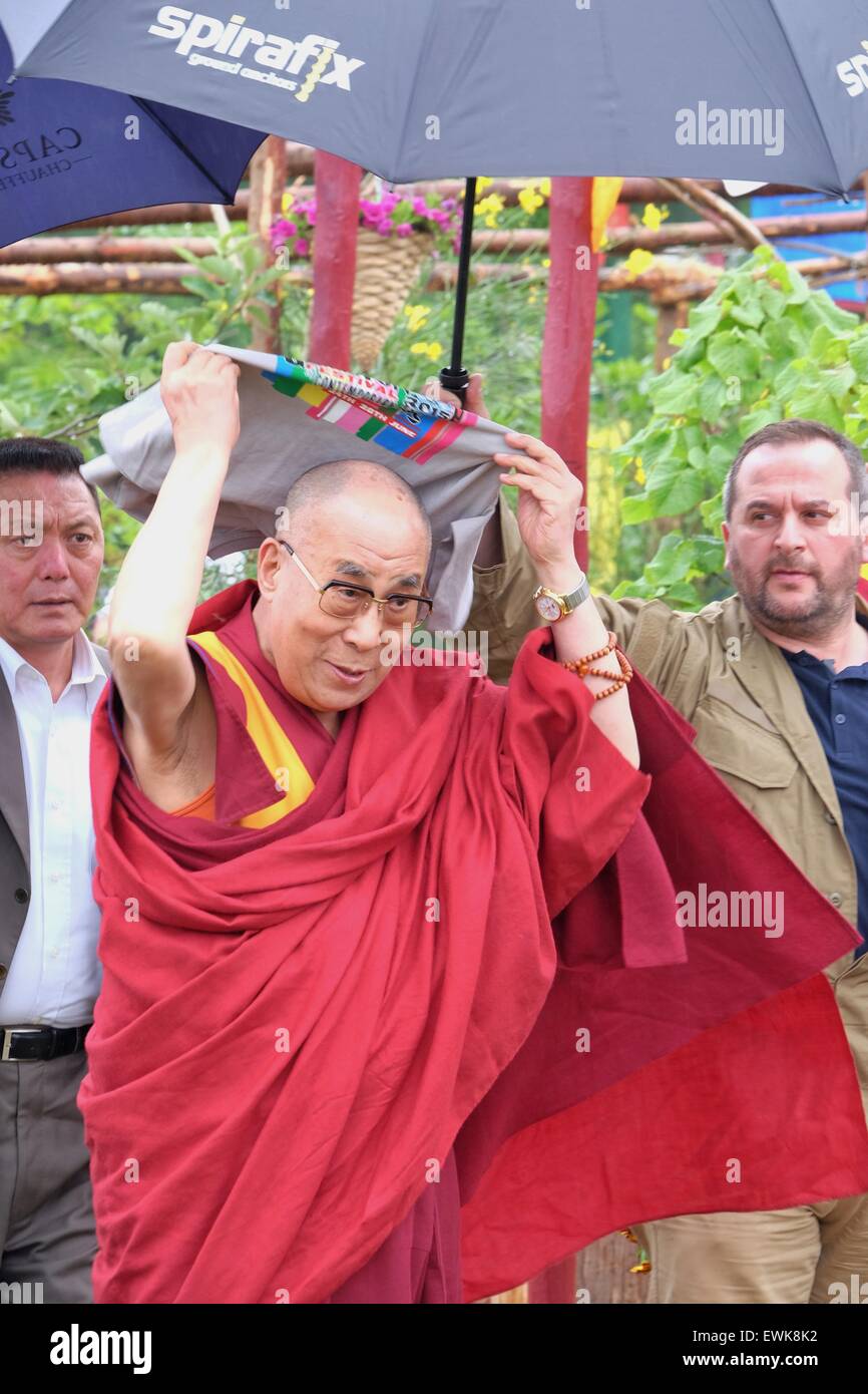 Glastonbury Festival, Somerset, UK. 28th June 2015. His Holiness the 14th Dali Lama uses a Glastonbury Tee  shirt whilst on his way to  celebrated his 80th year whilst address the Glastonbury Festival from the Peace Garden where a large crowd sang 'Happy Birthday to You'. Security was tight during his visit where there were some demonstrators. Credit:  Tom Corban/Alamy Live News Stock Photo