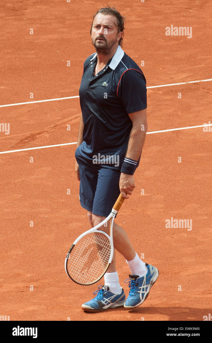 Berlin, Germany. 27th June, 2015. Former French tennis player Henri Leconte  plays against his German opponent M. Stich at the Grand Champions  Tournament in Berlin, Germany, 27 June 2015. Photo: OLIVER MEHLIS/dpa/Alamy