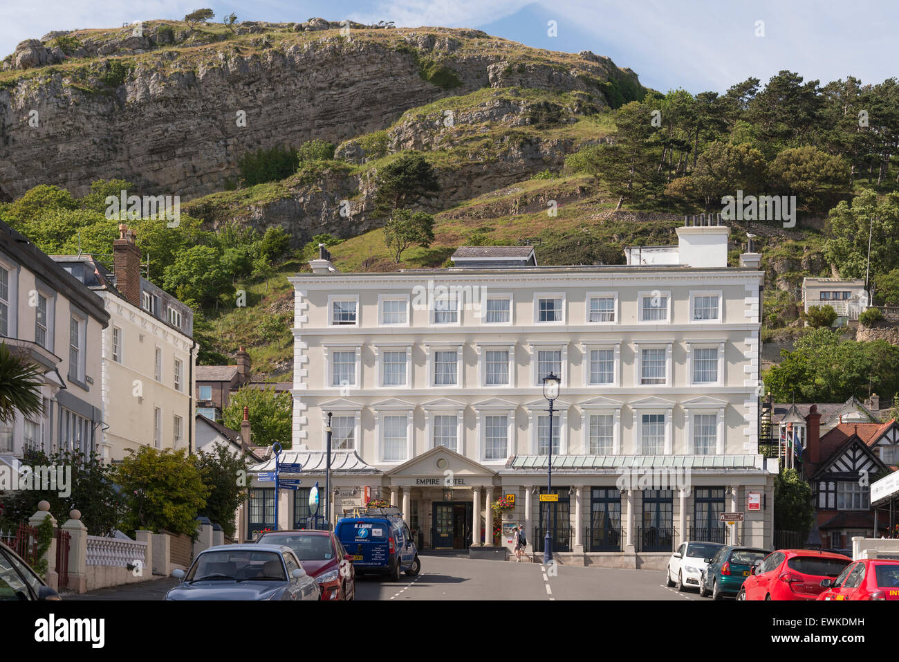 The Empire hotel nestling under the rocks of the Great Orme in Llandudno. Clwyd North Wales. Stock Photo