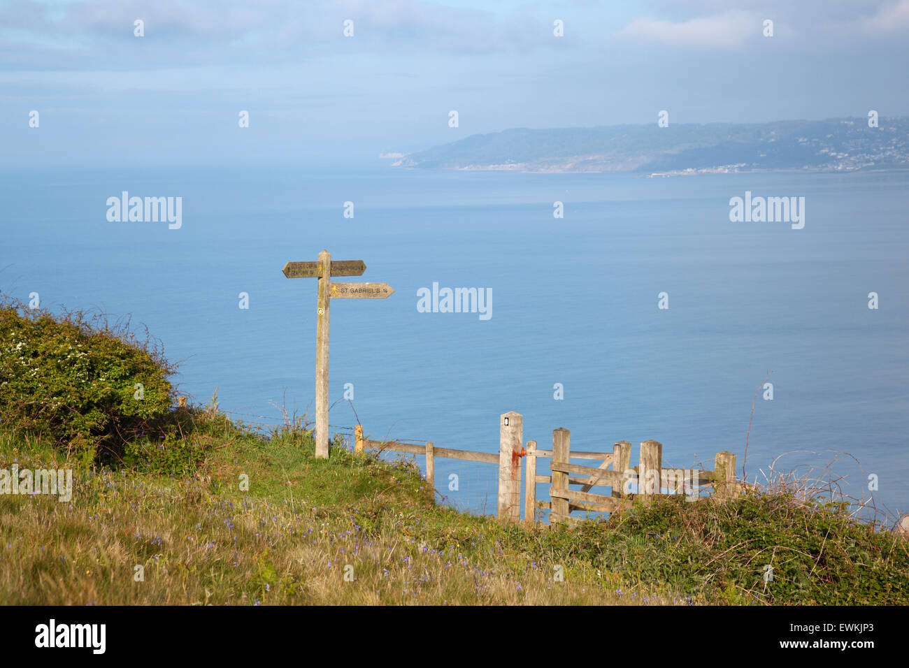 Signpost and Kissing Gate on the South West Coast Path, overlooking Lyme Bay. Dorset. England. UK. Stock Photo