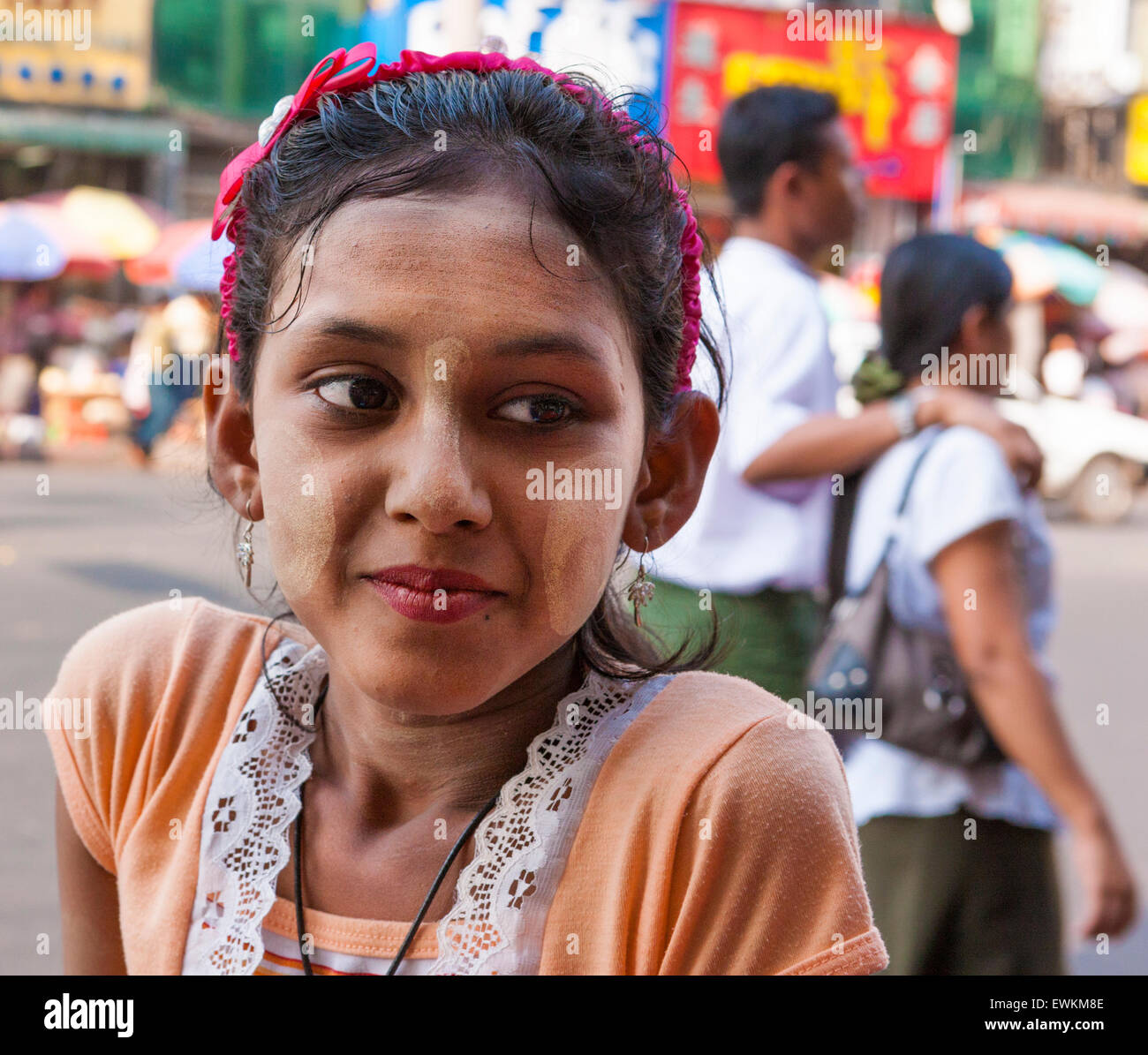 Thanaka clad girl on Yangon Street Stock Photo