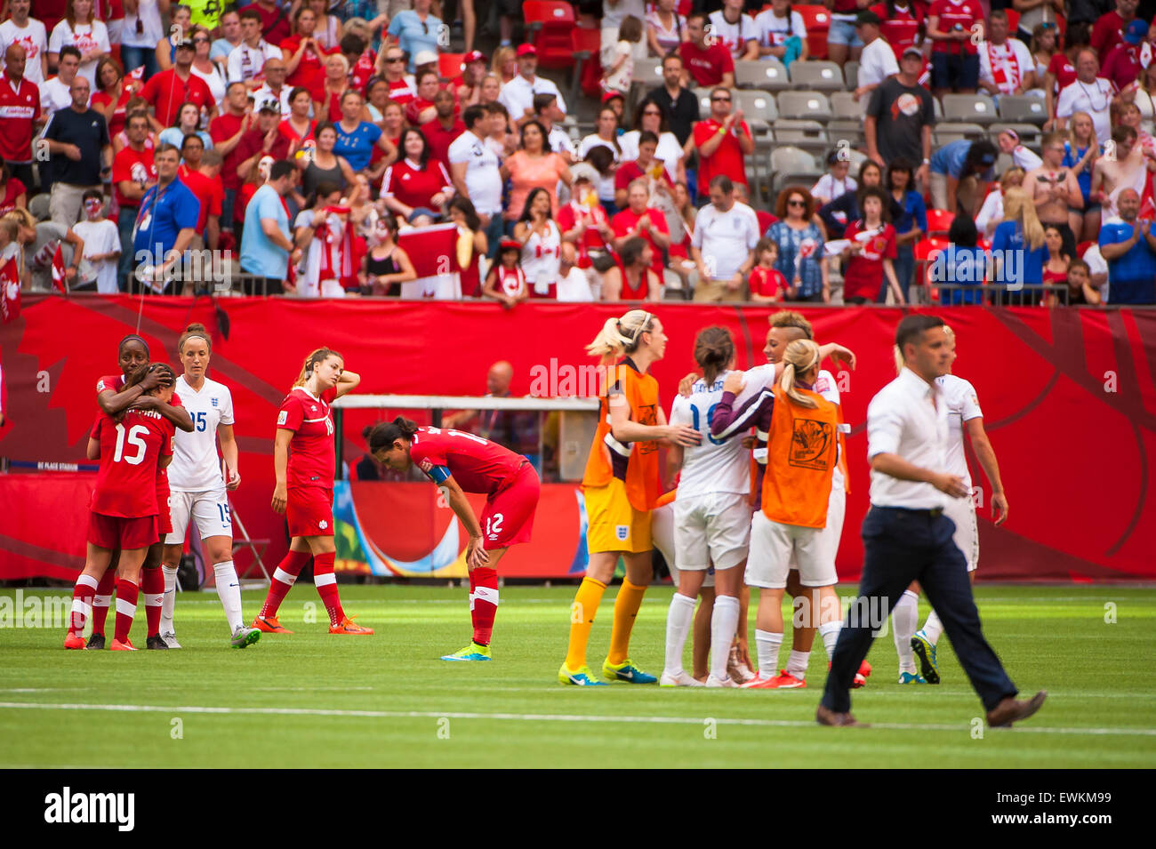 Vancouver, Canada. 27th June, 2015. England players celebrate and Canadian players react following the quarterfinal match between Canada and England at the FIFA Women's World Cup Canada 2015 at BC Place Stadium. England won the match 2-1. Credit:  Matt Jacques/Alamy Live News Stock Photo