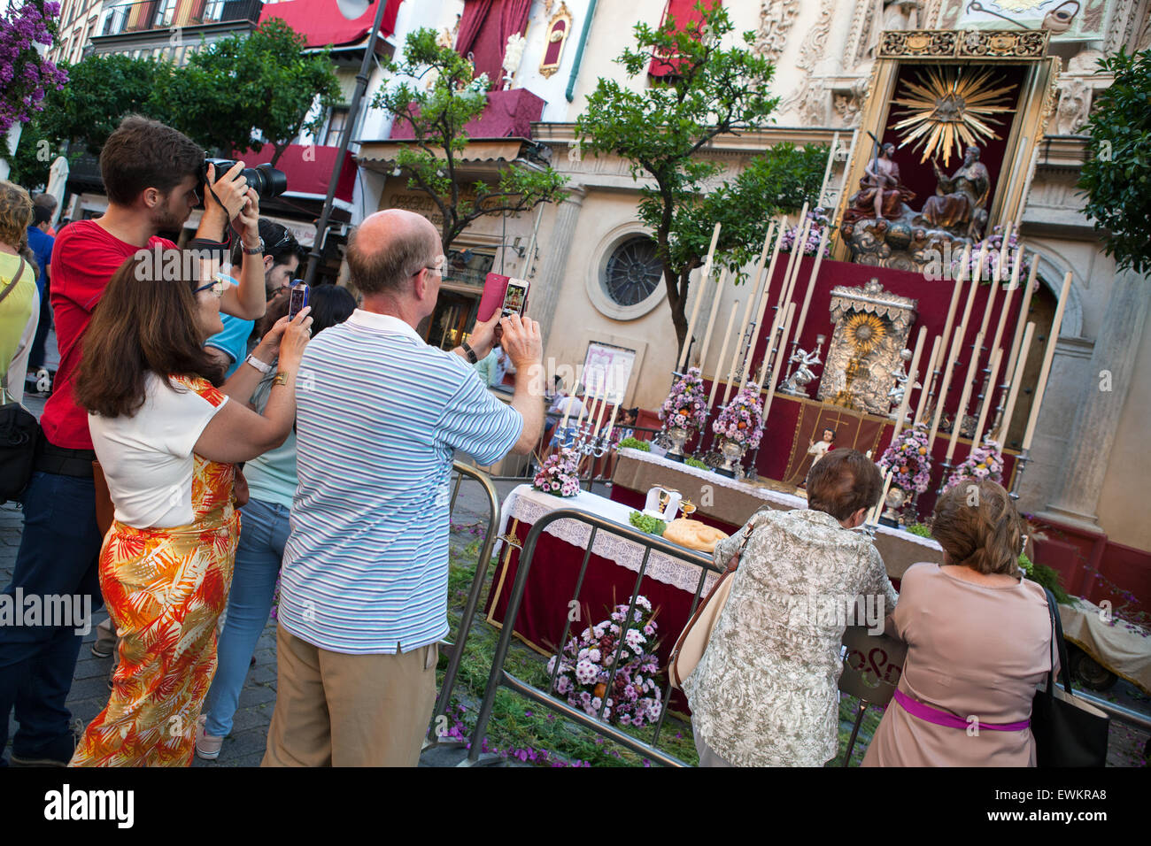 Tourists take photographs of a shrine in front of the Iglesia Colegial Divino Salvador during the feast of Corpus Christ Stock Photo