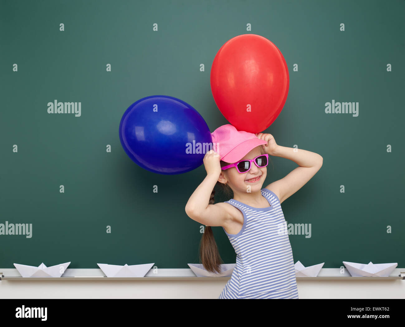 girl with balloon near the school board Stock Photo Alamy
