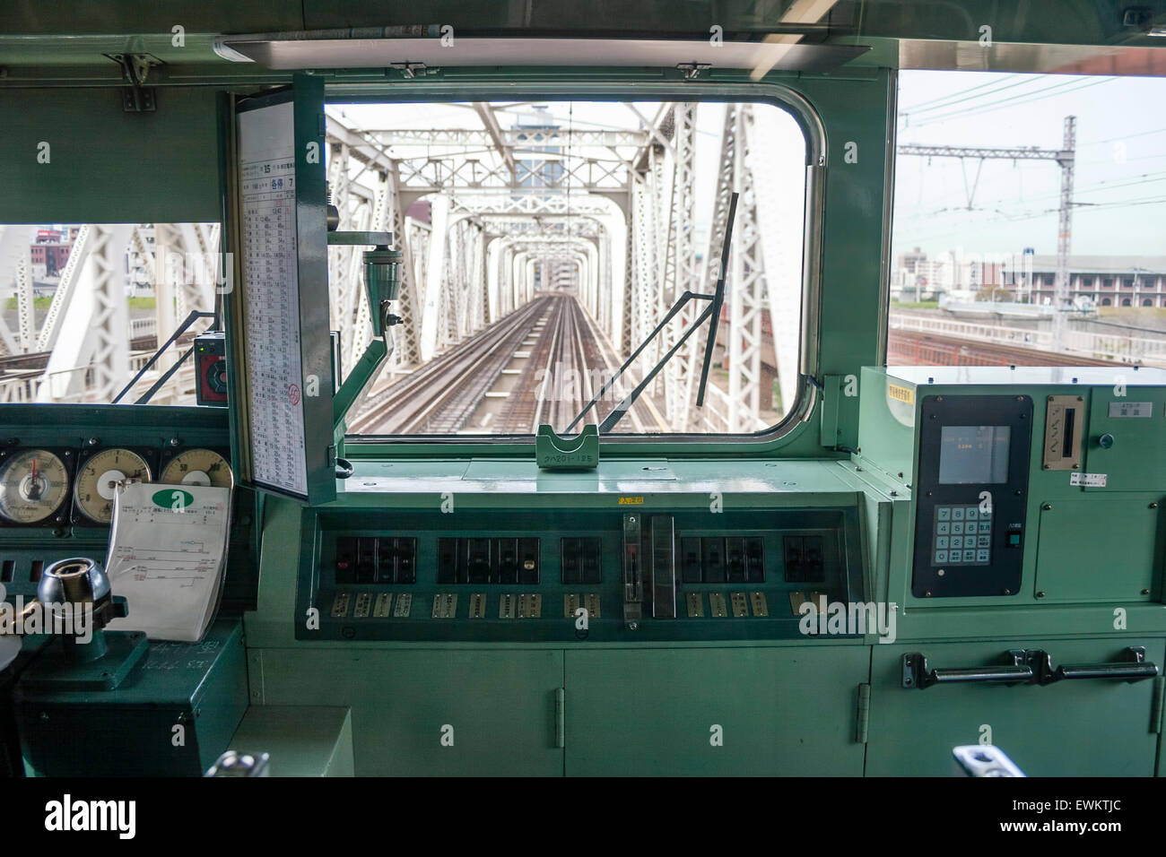 Japanese railway commuter train. Front view through the driver cab