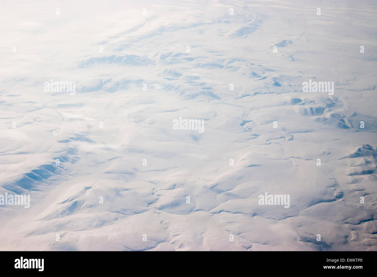 Aerial view from plane of North eastern Russia, Siberia. Tundra region covered by thick snow, view from 30,000 feet. Stock Photo