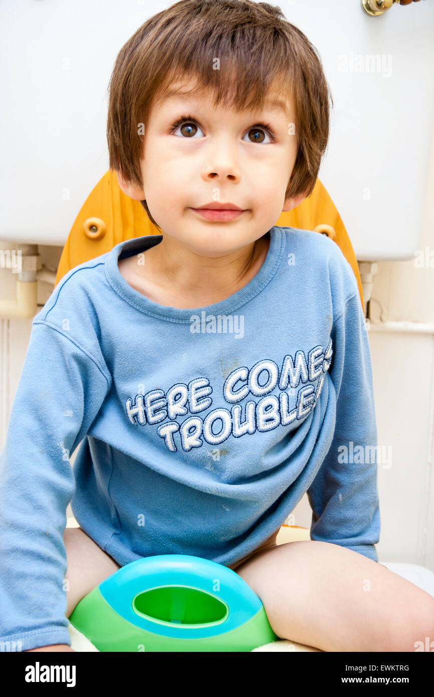 Caucasian young child, boy, 45 year old, facing viewer and sitting on