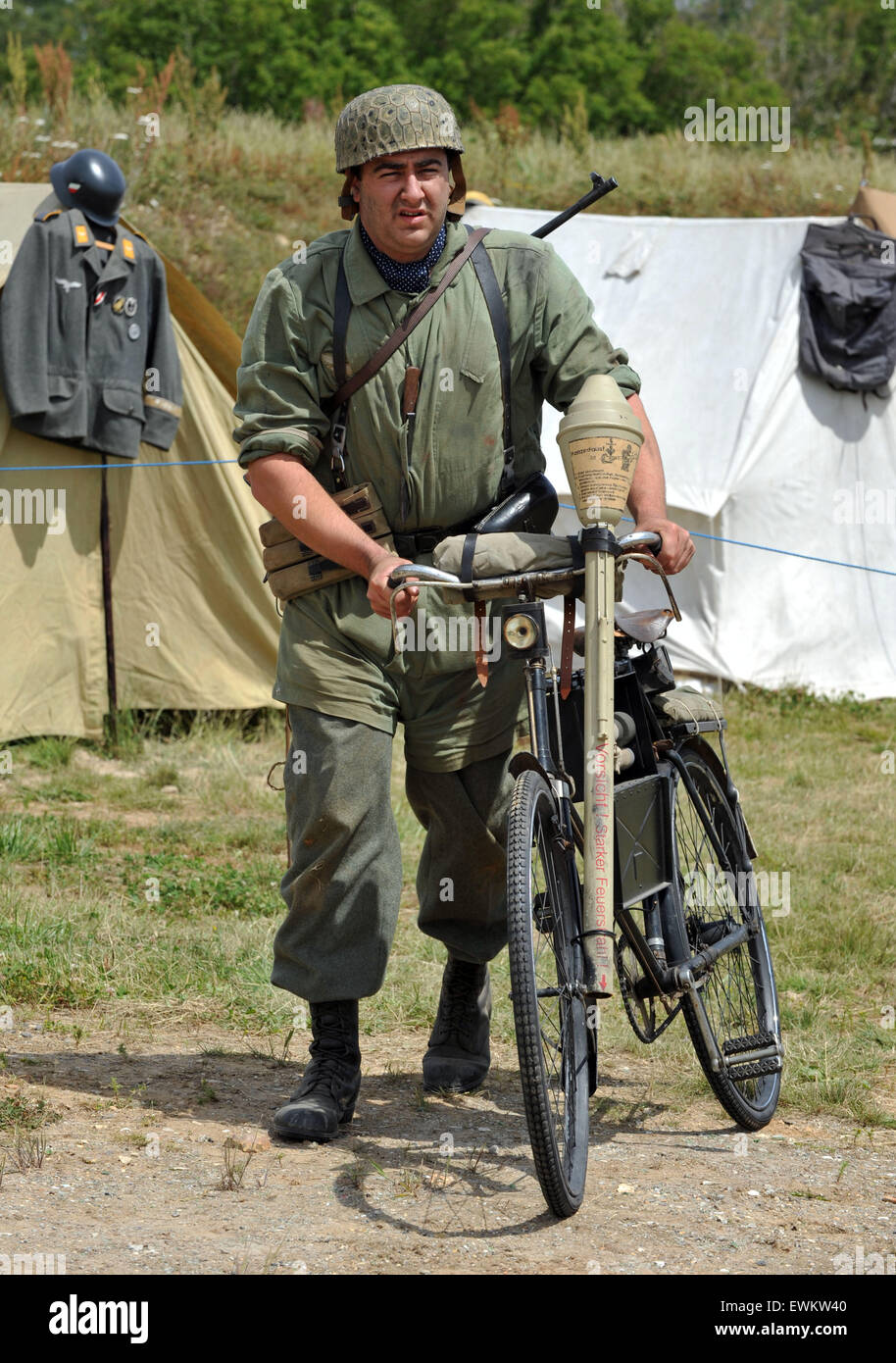 German parchute soldier with his bike. Tank Fest at Bovington in Dorset.  The two day event showing off armoured military vehicles drew sell-out crowds of over nearly 30,000 over the two days. The museum has the largest collection of working armour in the world from the period of World War I up to the present day and from nations all over the world.   Stock Photo