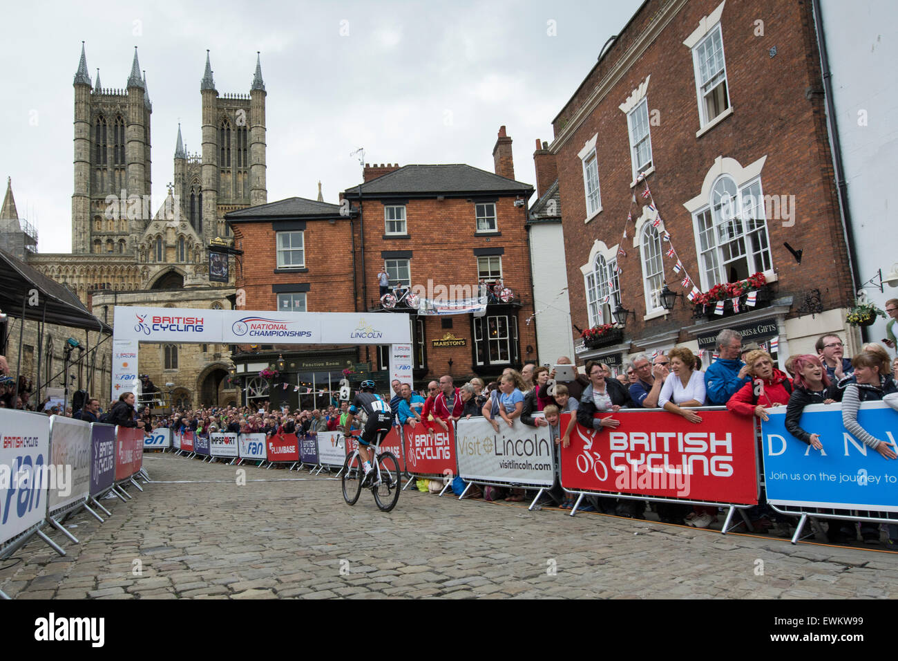 Lincoln, UK. 28th June, 2015. Race winner Peter Kennaugh (Team Sky) leads the race past Lincoln Cathedral with 3 laps to go in the British Cycling Road Race Championships at Lincoln, United Kingdom on 28 June 2015. Credit:  Andrew Peat/Alamy Live News Stock Photo