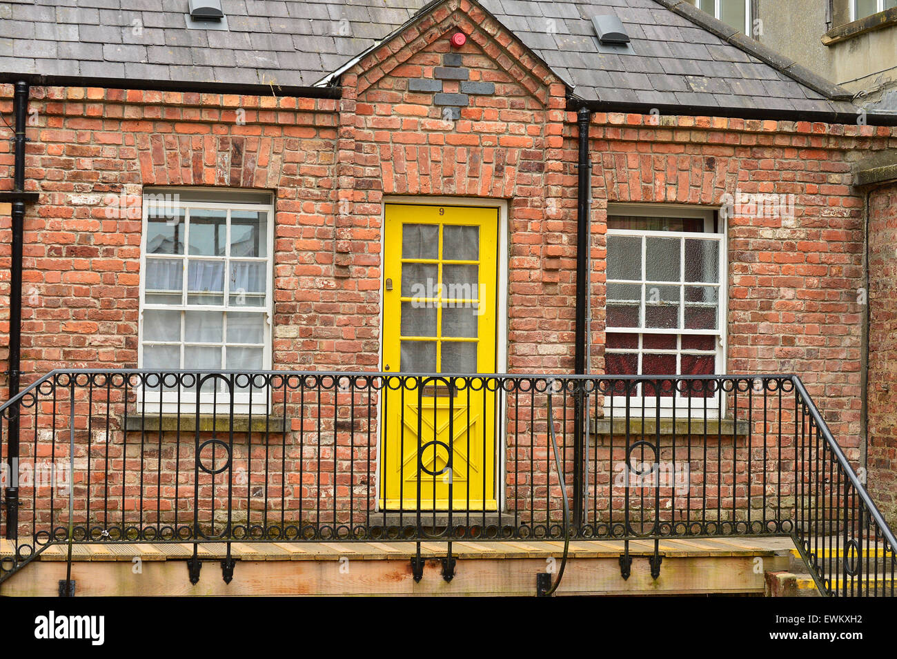 Red brick exterior and colourful doors of apartments in the Craft Village, Londonderry (Derry), Northern Ireland Stock Photo