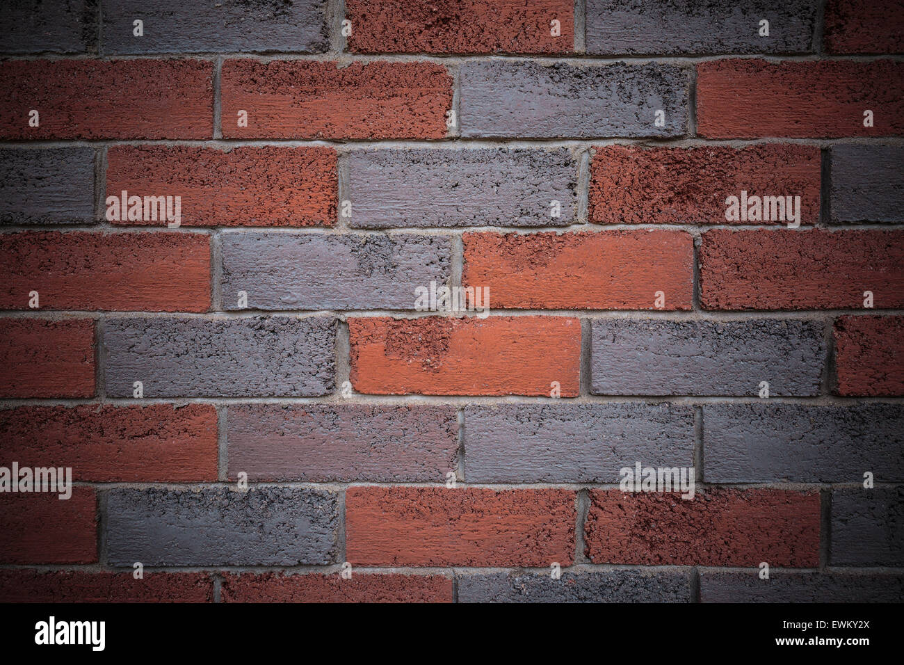 Red and grey brick wall with vignette. Useful as background or backdrop Stock Photo