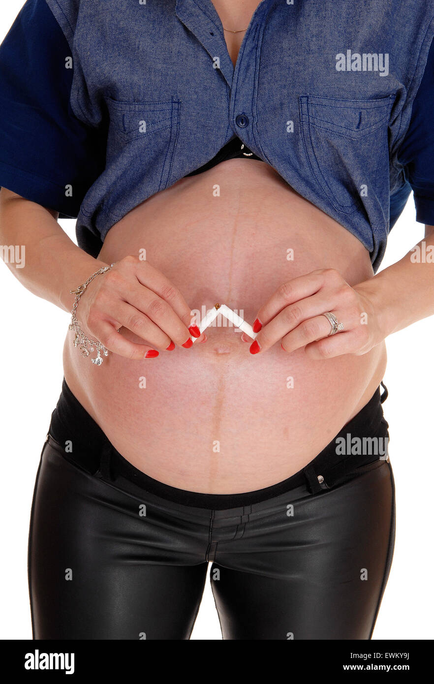 cigarette in navel Pregnant Woman With Belly Holding A Hands Concept Of Smoking And Bad Habits During Pregnancy Stock Photo Cigarette in belly button hi-res