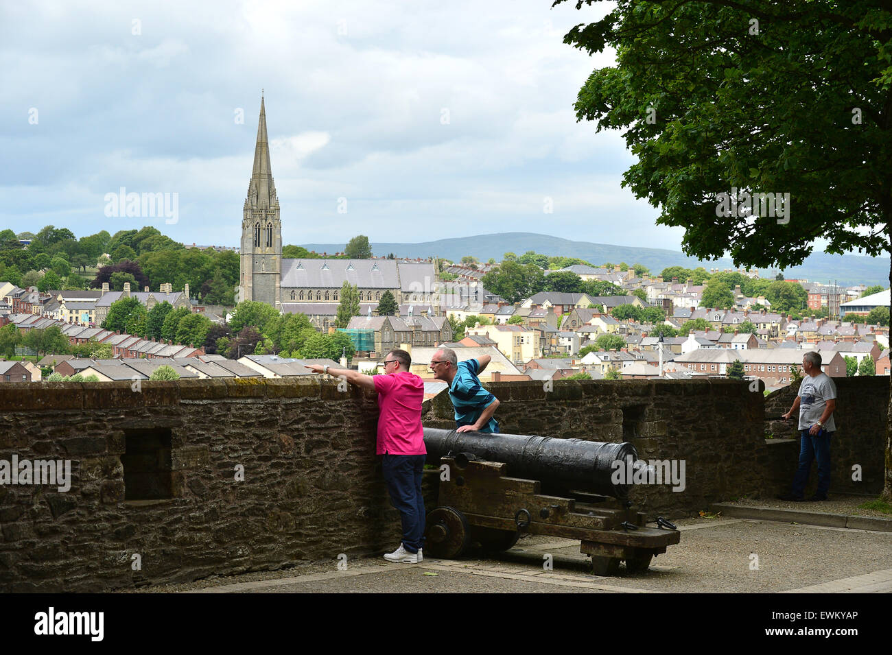 Tourists walk on the 17th century Derry Walls in Londonderry, Northern Ireland. Stock Photo