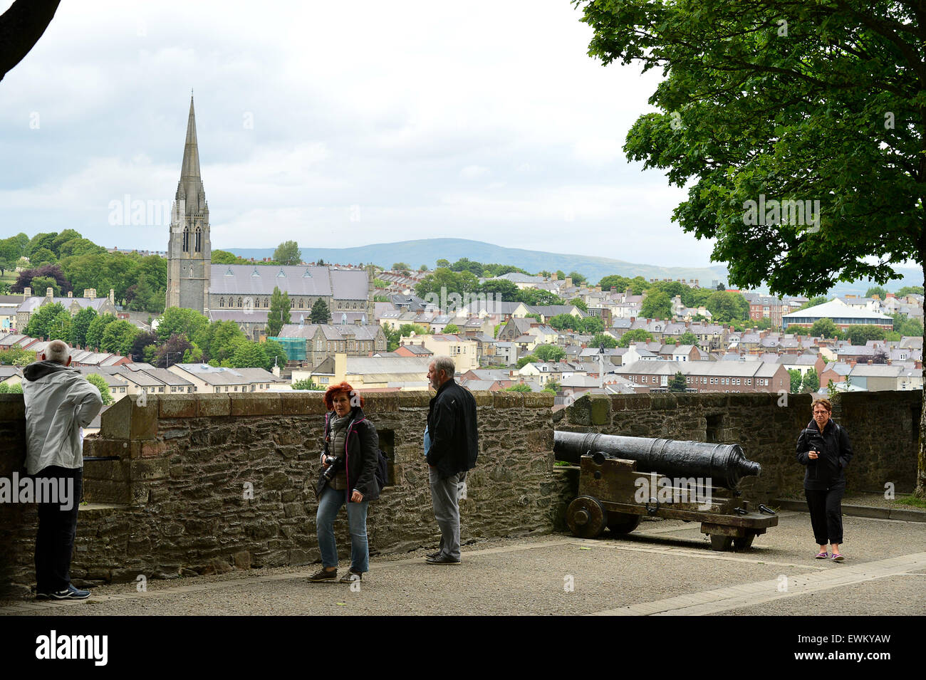 Tourists walk on the 17th century Derry Walls in Londonderry, Northern Ireland. Stock Photo