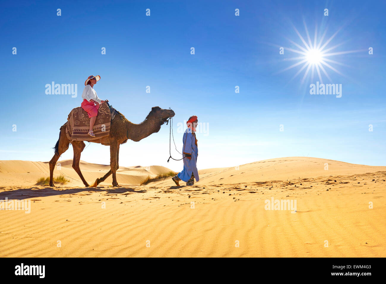 Tourist on camel ride, Erg Chebbi desert near Merzouga, Sahara, Morocco Stock Photo