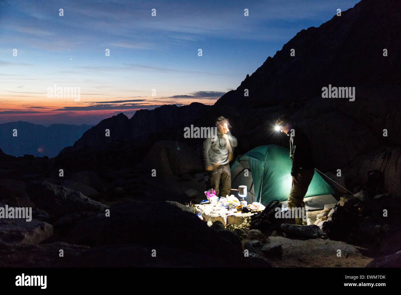 Backpackers prepare breakfast before dawn at Trail Camp before summiting Mt. Whitney. Stock Photo
