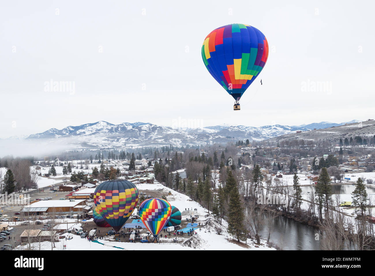 A hot air balloon rises from the snow covered ground at the Winthrop Balloon Festival. Stock Photo