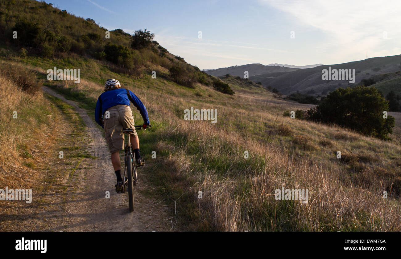 A mountain biker races down a trail in the Santa Monica Mountains, Stock Photo