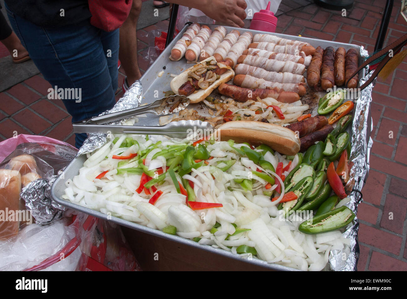 Street vendor selling bacon wrapped hot dogs from their portable grill in San Francisco, California. Stock Photo