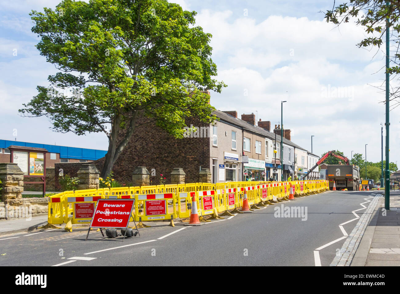 Contractors replacing a gas main in busy road in the Village Centre  Marske by the Sea Cleveland North Yorkshire England UK Stock Photo