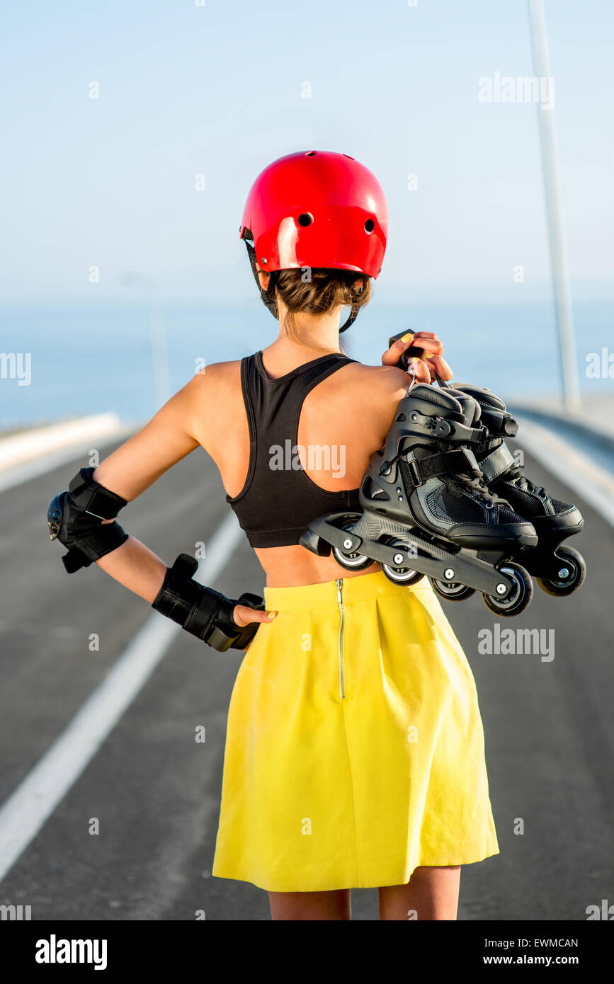 Sport woman with rollers on the highway Stock Photo