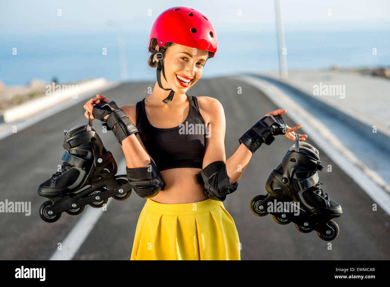 Sport woman with rollers on the highway Stock Photo