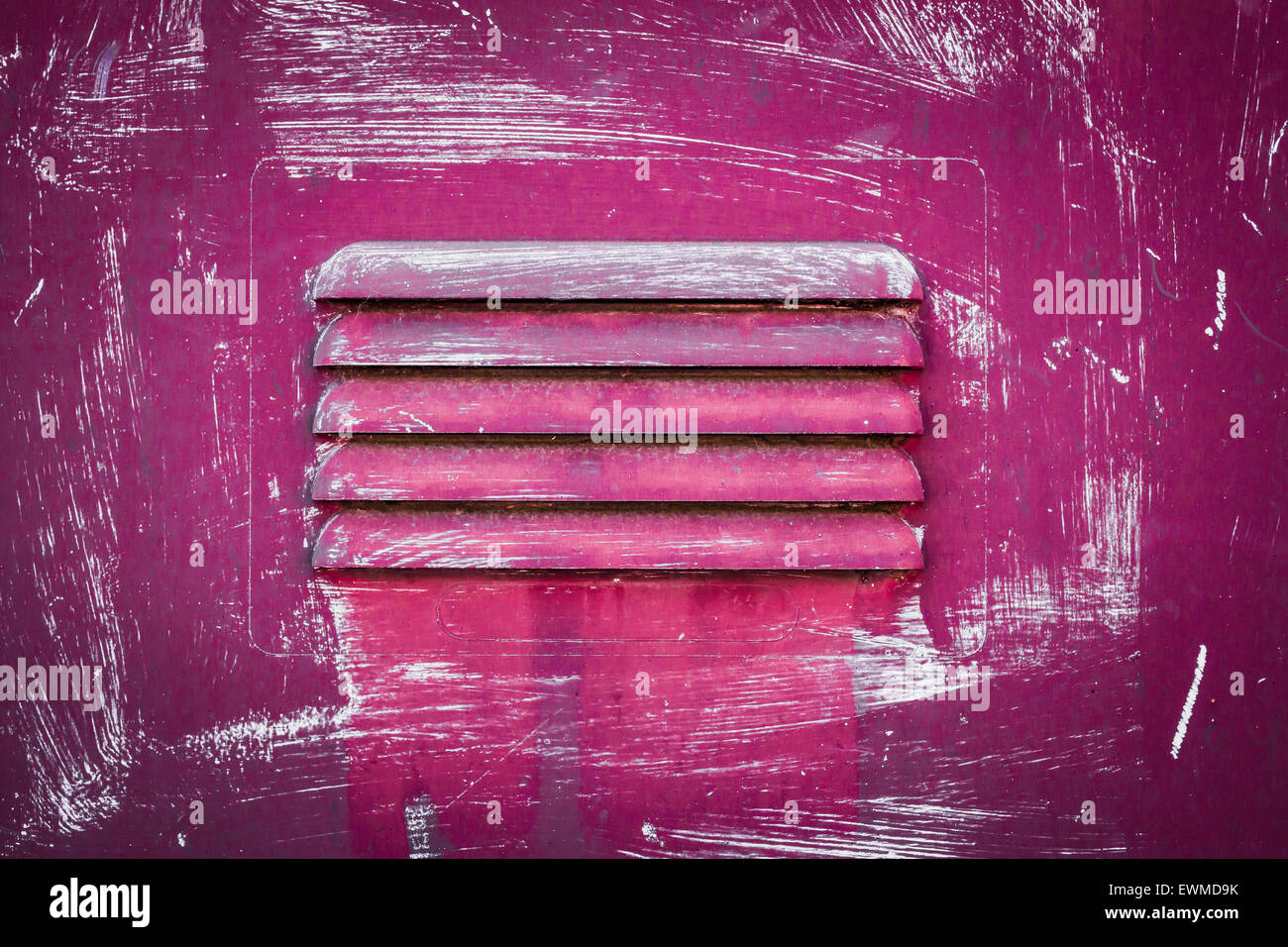 A rusty panel with grate, painted pink. Stock Photo