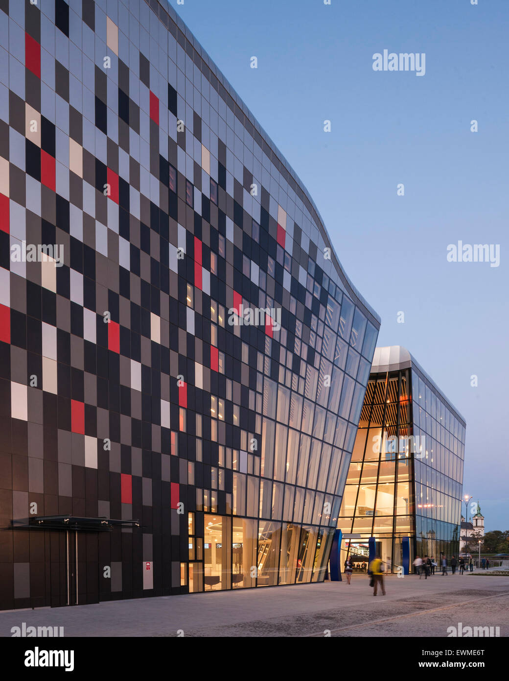 Ceramic exterior facade with entrance at dusk. ICE Krakow Congress