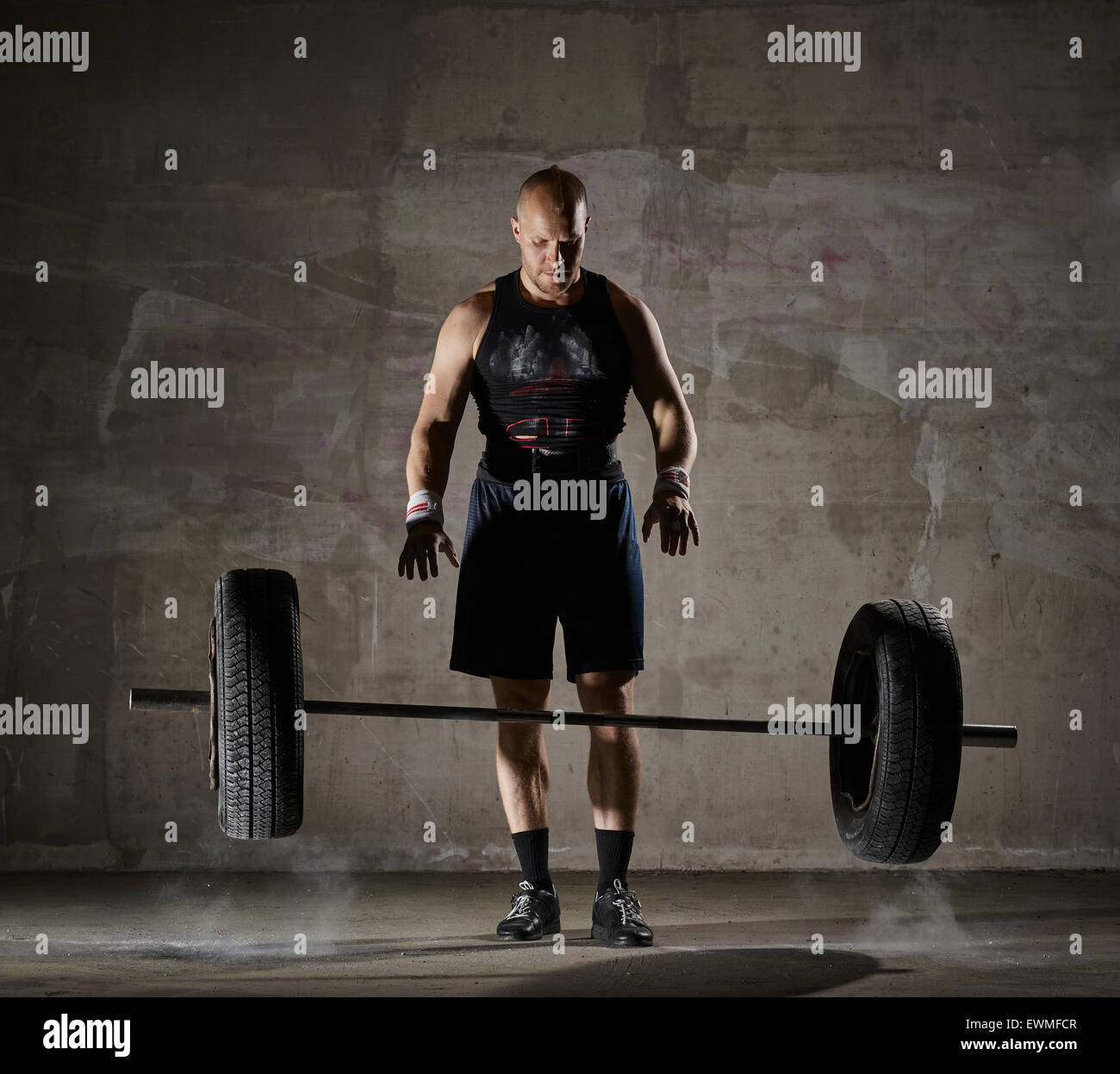 Weight lifting, athletic man and daily training inside the concrete building Stock Photo