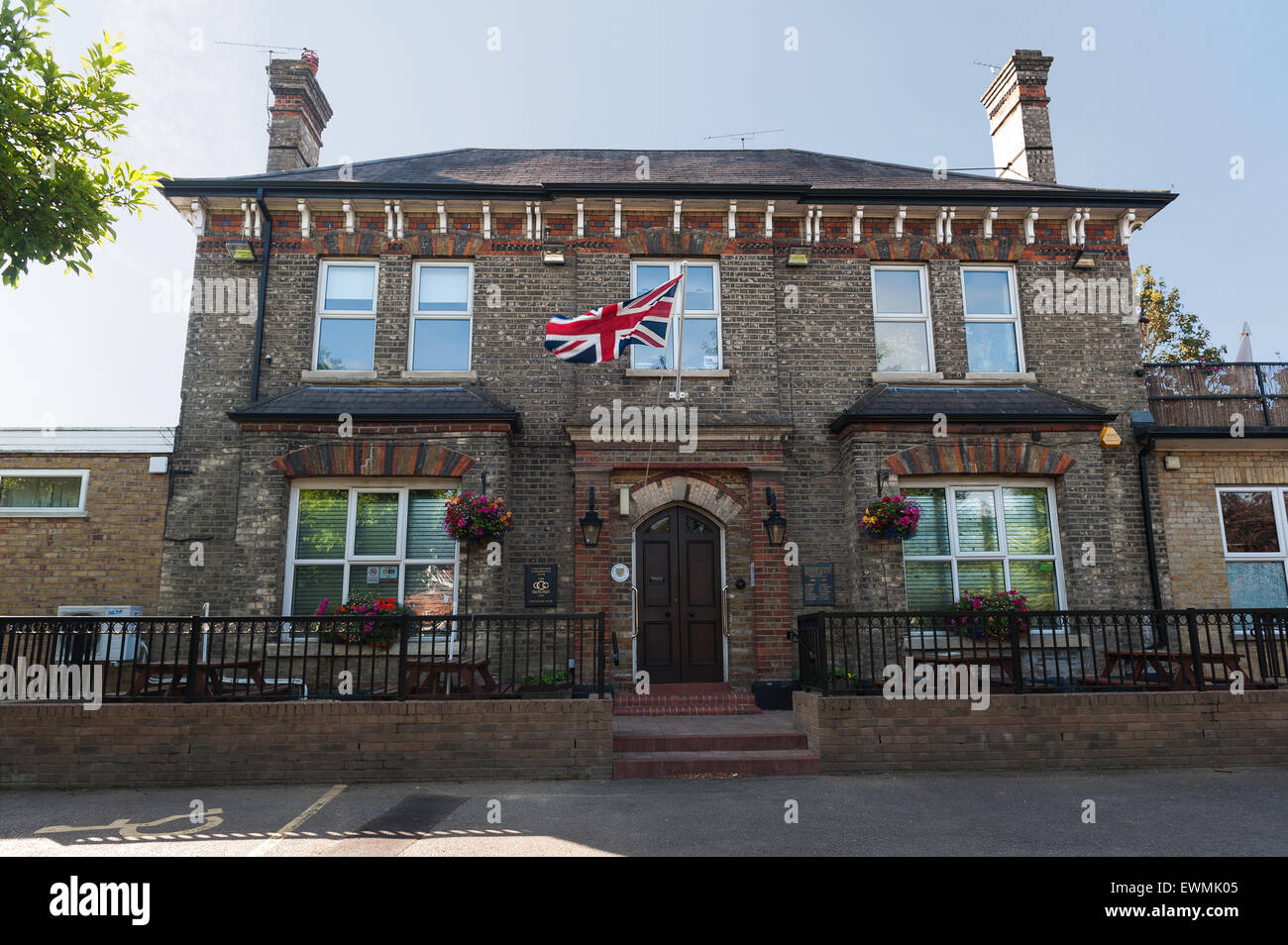 Union Jack flag flying above entrance to Chelmsford Conservative Social Club main entrance Stock Photo