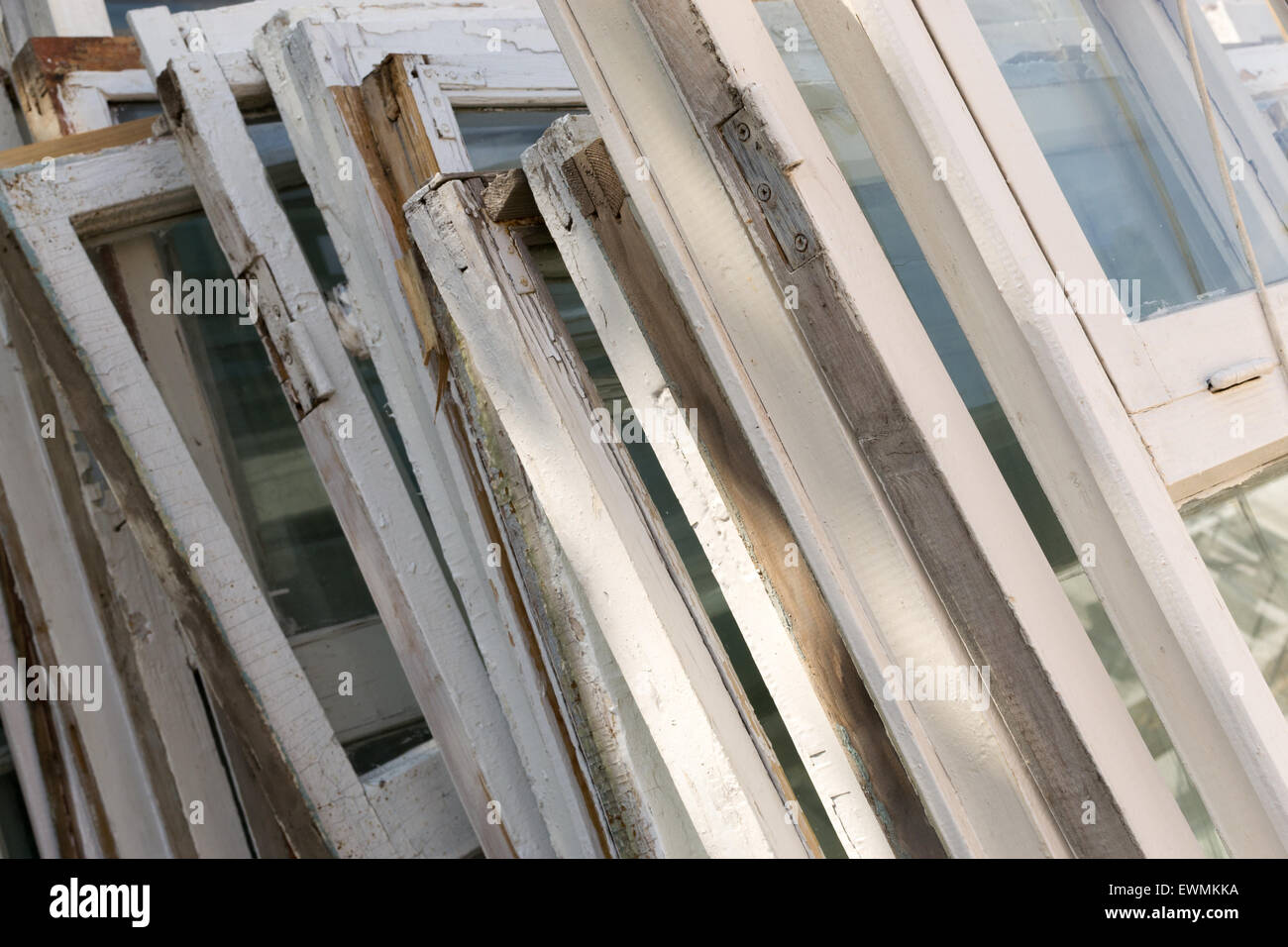Old flaking window frames in white paint piled up in a row Stock Photo ...