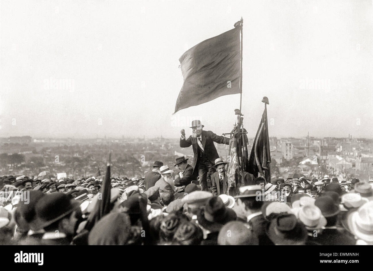 Jean Jaurès (1859-1914), speaking at a demonstration against the French law increasing the term of military service from 2 to 3 years in preparation for possible war with Germany which started the next year. The demonstration took place on 25 March 1913 in Pré-Saint-Gervais, Paris. To Jaurès left is seated Pierre Renaudel (1871-1935) founder of the Socialist Party of France (PSdF). The party was anti-war until the assasination of Jean Jaurès at the outbreak of World War I. Stock Photo