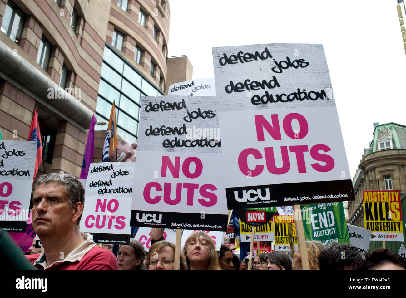March against austerity, London June 20th 2015. protesters carry placards saying 'Defend jobs, defend education, No Cuts' Stock Photo