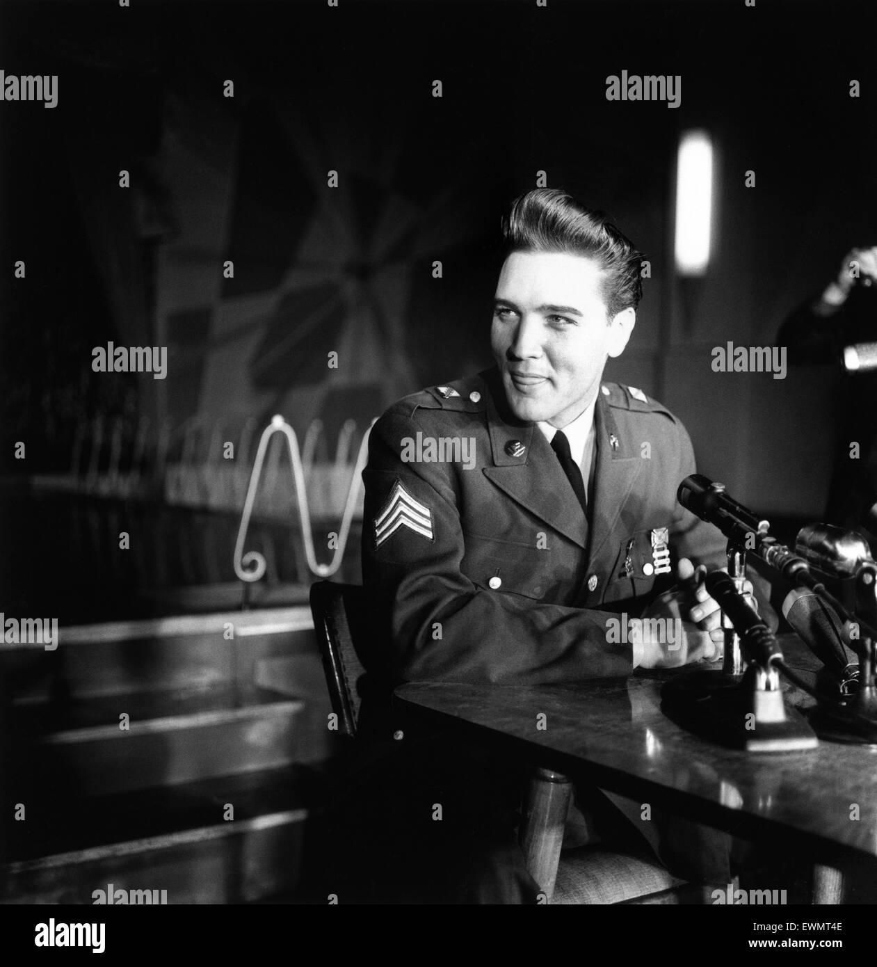 American rock and roll singer and musician Elvis Presley pictured wearing army uniform as he attends a press conference in Germany. March 1960. Stock Photo