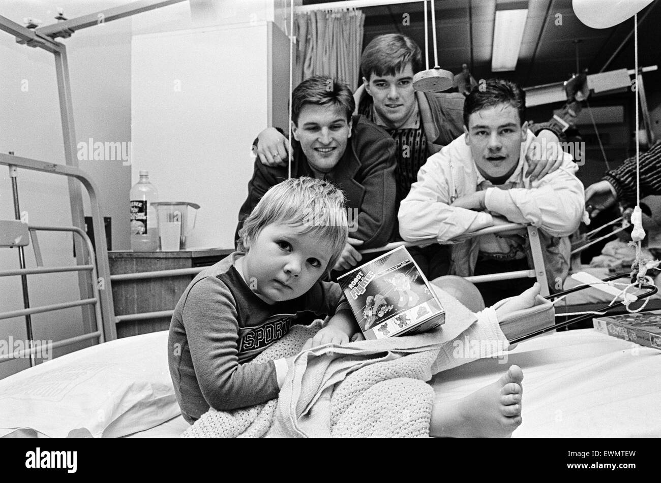 Middlesbrough footballers hand out presents donated by kind-hearted Teessiders to the Evening Gazette's Give a Little appeal to children at Middlesbrough General Hospital. Garry Gill, Gary Pallister and Gary Hamilton with three-year-old Colin James. 22nd Stock Photo