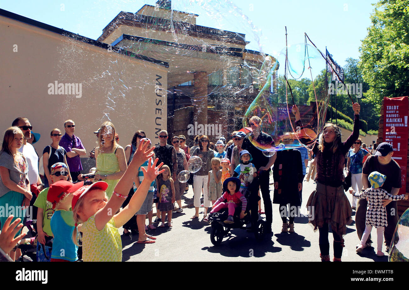 (150629) -- TURKU, June 29, 2015(Xinhua) -- Some kids chase the soap bubbles during the annual Medieval Market in Turku, southwest Finland, on June 28, 2015. The Medieval Market is Finland's largest medieval and historical event held at the Old Great Square of Turku from June 25 to 28. During the four-day event, merchants sold traditional food and handicrafts, and actors performed scene play dressed in ancient costumes. (Xinhua/Zhang Xuan)(azp) Stock Photo