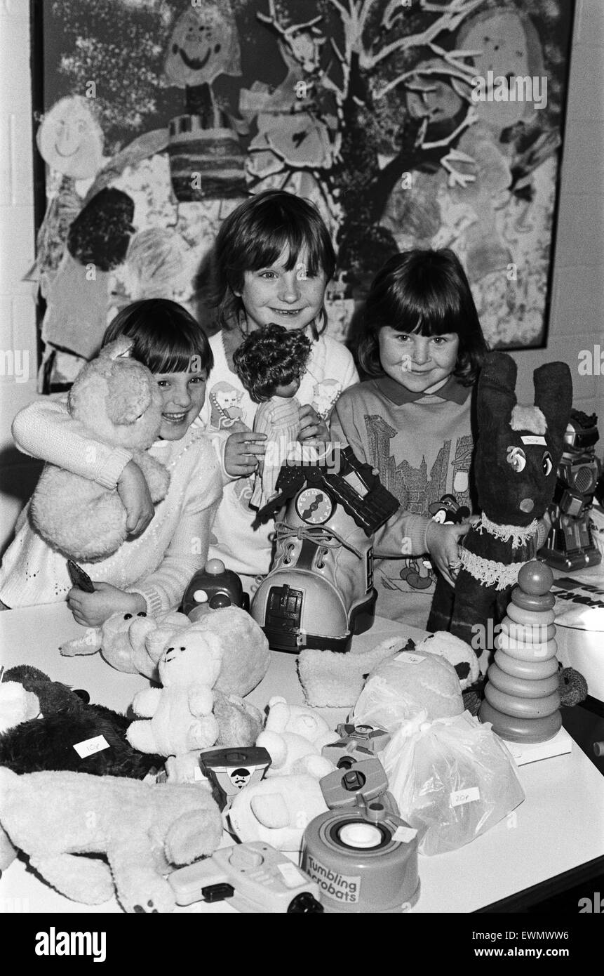 Toy time... looking after the toy stall at a Christmas fair held at Almondbury Infants School are (from left) Eleanor Chivers, five, Jennifer Chivers, seven and Laura Emsell, six. The event was opened by Yorkshire cricketer Mr Arnie Sidebottom, whose seve Stock Photo