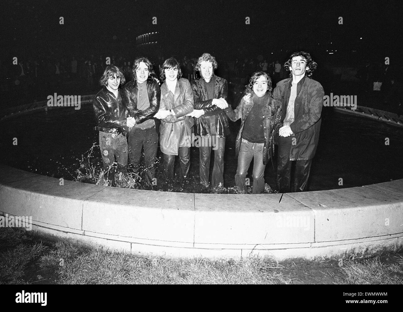 New Year Revellers seeing in 1973 by taking a quick dip in the fountain in Centenary Square Birmingham and singing Auld Lang Syne . 31st December 1972 Stock Photo
