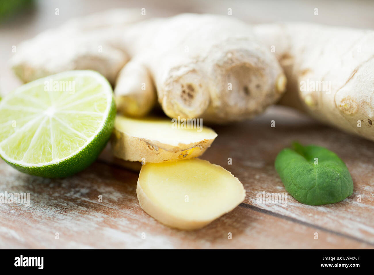 close up of ginger root and lime on wooden table Stock Photo