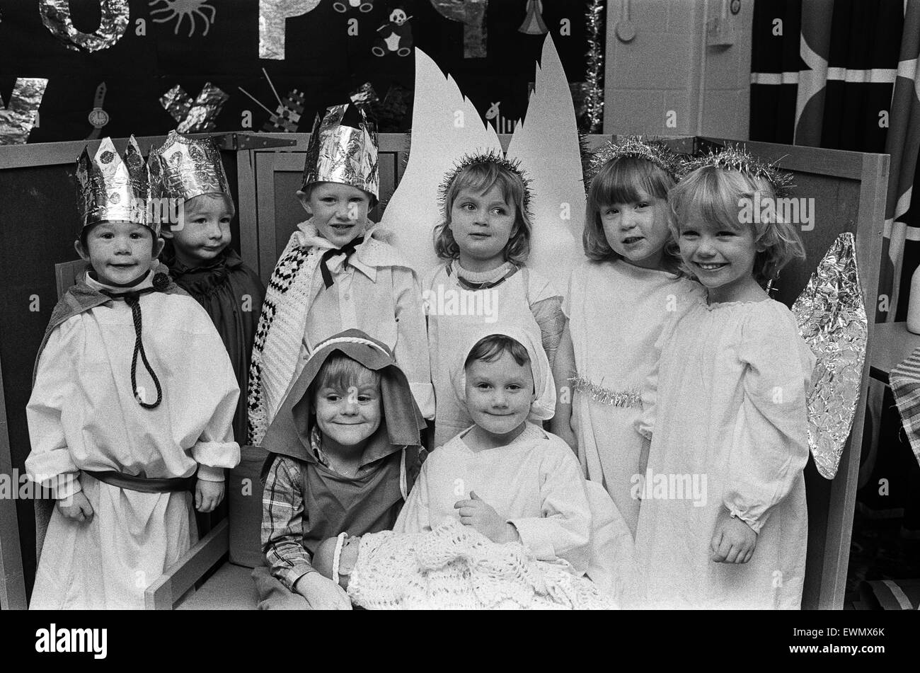 Putting a sparkle into Christmas... a beaming Joseph and Mary, otherwise four-year-olds Christopher Sykes and Sarah Hunter (front), are seen with Three Kings and angels at Almondbury CofE Infants School, Longcroft. 18th December 1986. Stock Photo