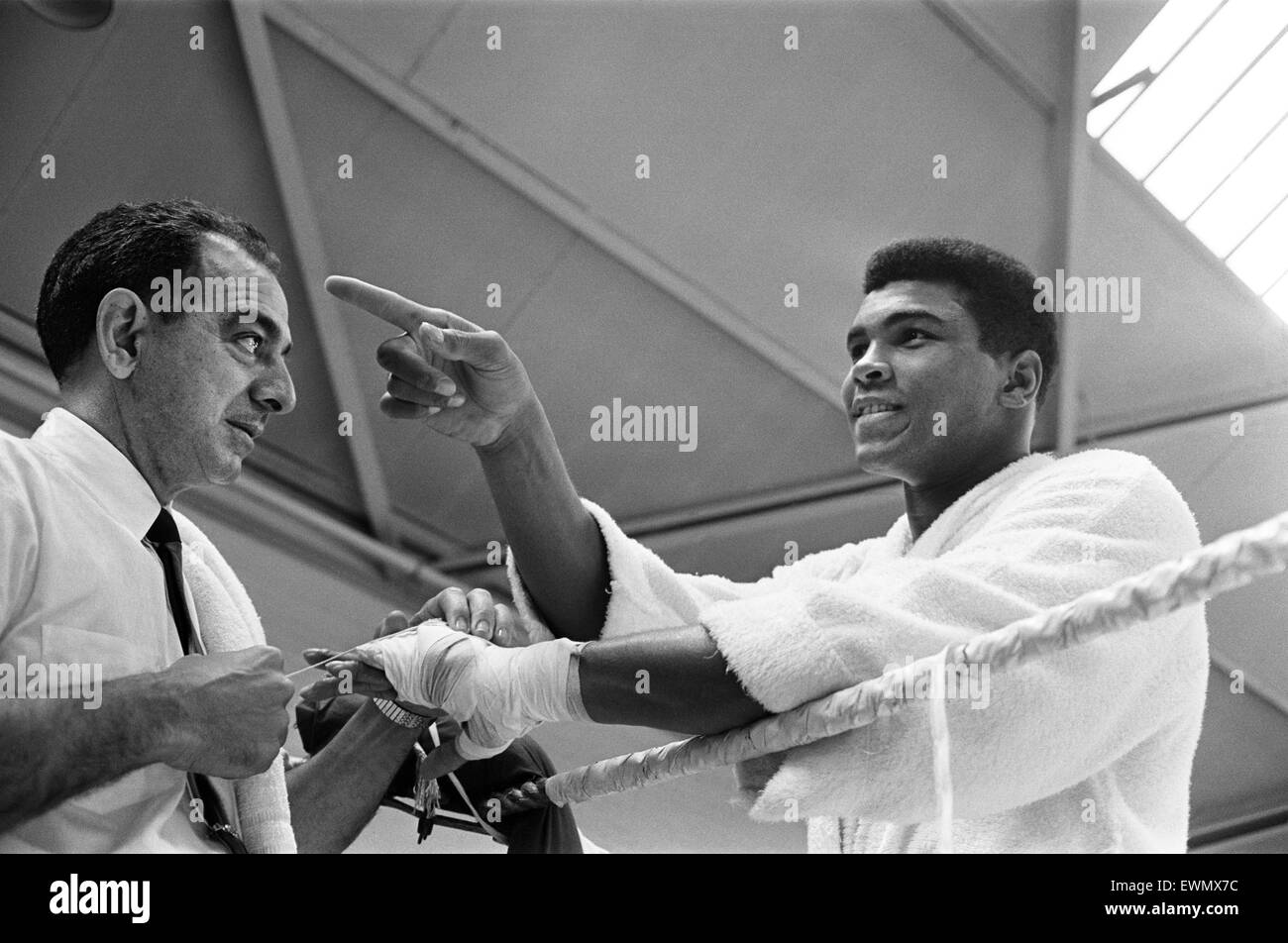 Cassius Clay aka (Muhammad Ali) getting his hands wrapped at White City training camp ahead of his rematch with Henry Cooper. 18th May 1966 Stock Photo