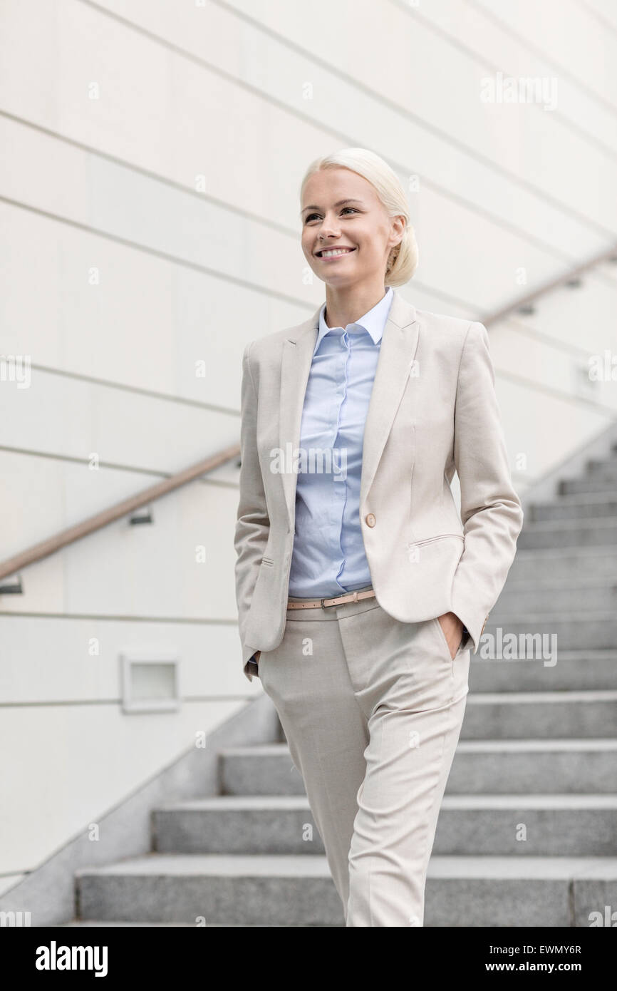 young smiling businesswoman walking down stairs Stock Photo - Alamy