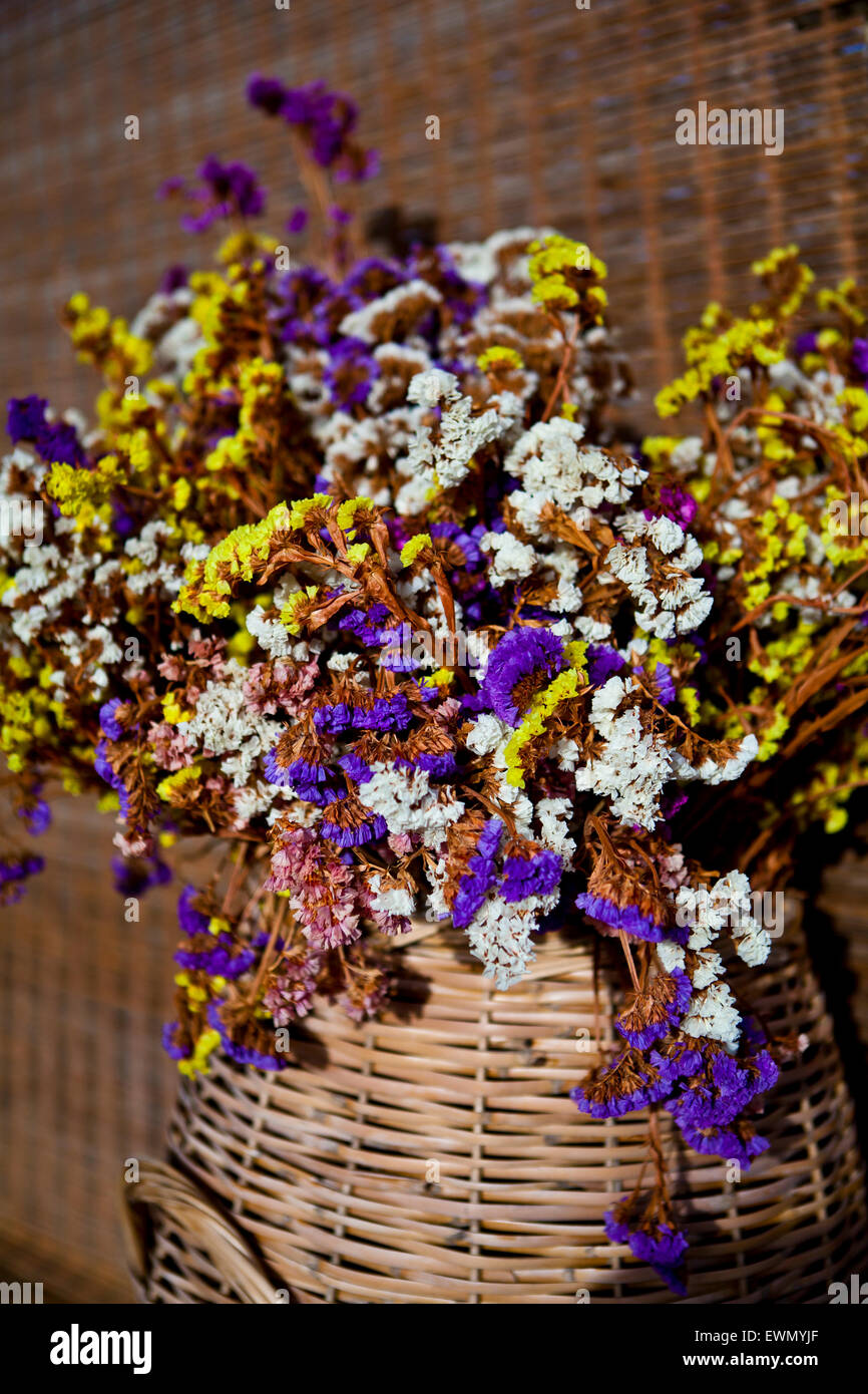 Mediterranean flowers in a wicker basket in Naxos in the Greek Islands Stock Photo