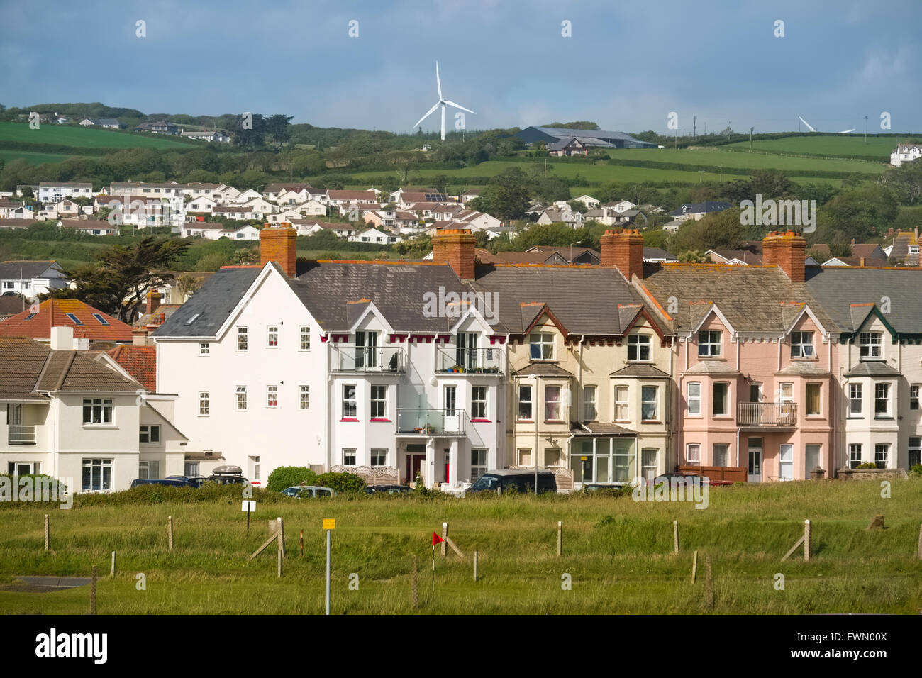 Terrace houses and wind turbines at Crooklets, Bude, Cornwall, England, UK Stock Photo