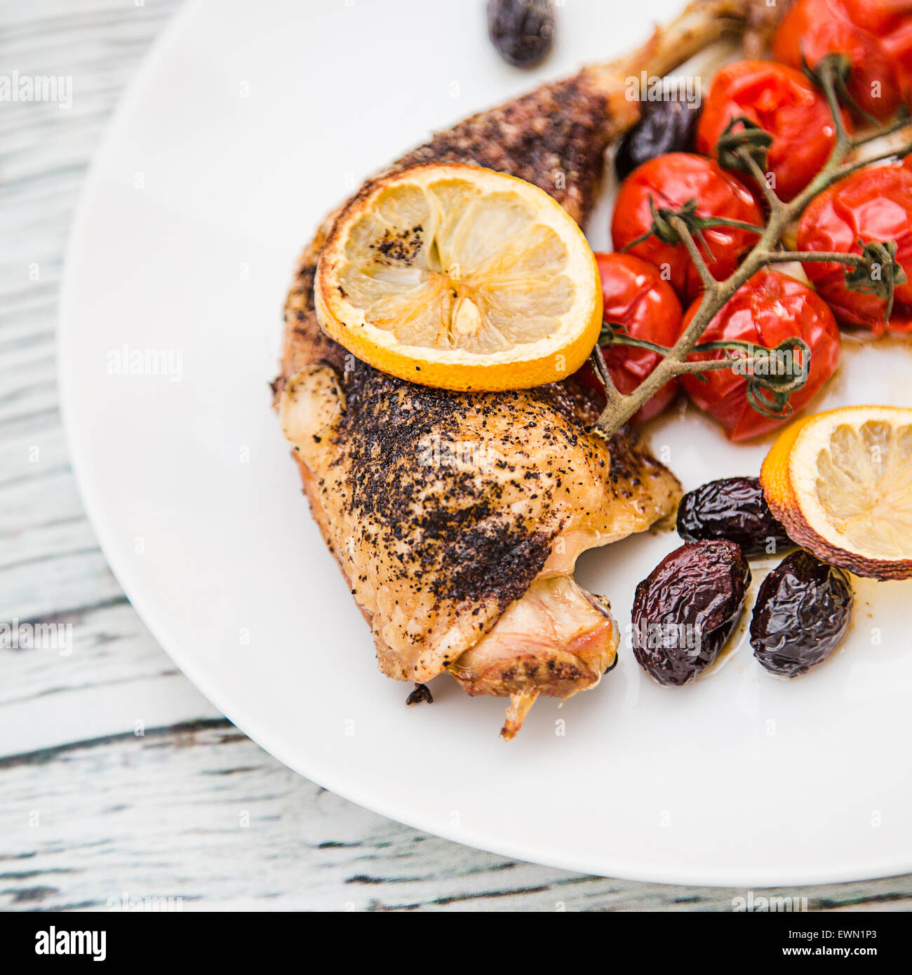 Oven Baked Sumac Chicken with Cherry Tomatoes and Kalamata Olives Stock Photo