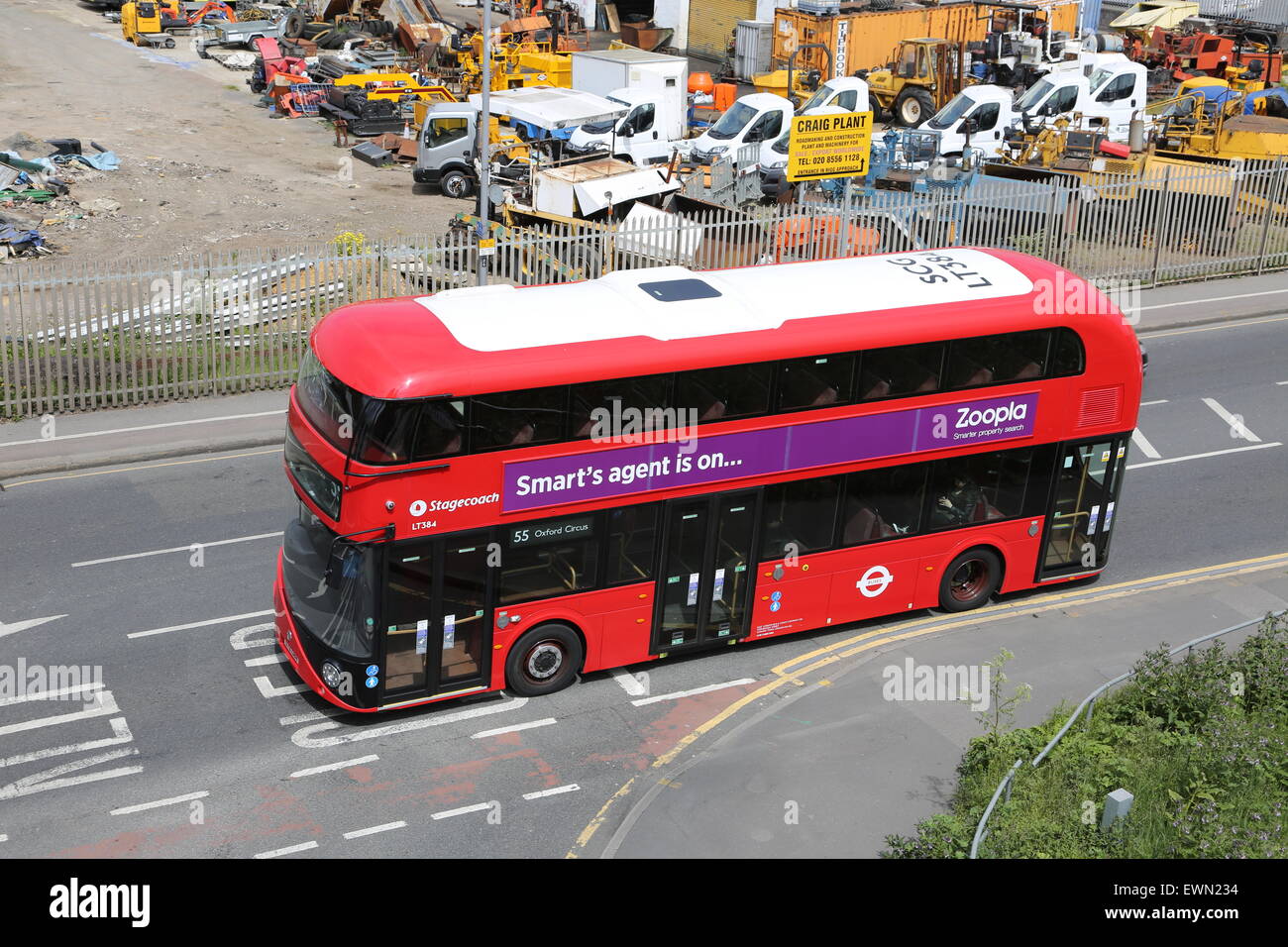High level view of one of London's new Routmaster double-deck buses. Shown passing a contractors yard on Lea Bridge Road. Stock Photo