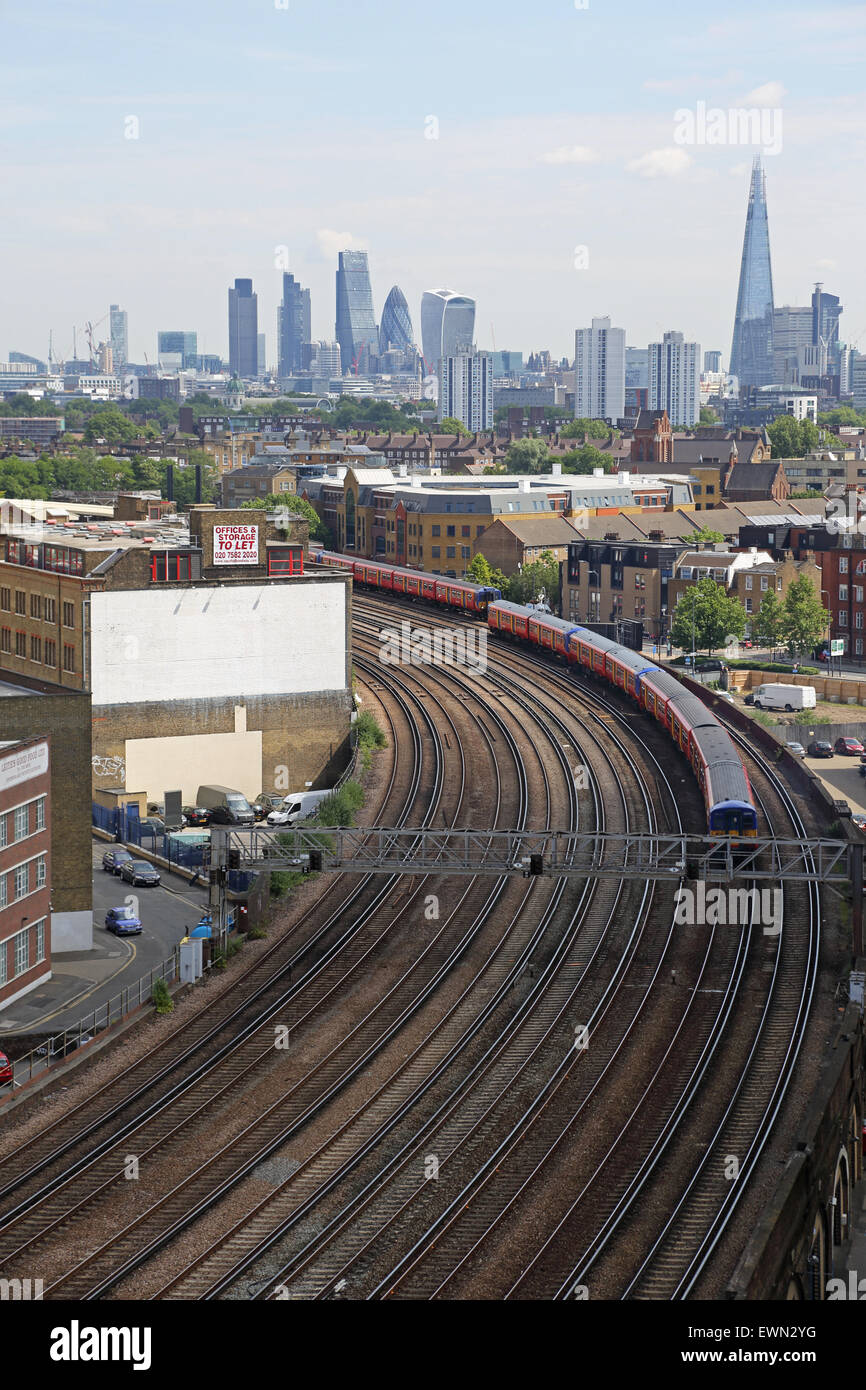 trains on rail tracks close to London's Vauxhall station with the skyline of the City of London in the background Stock Photo
